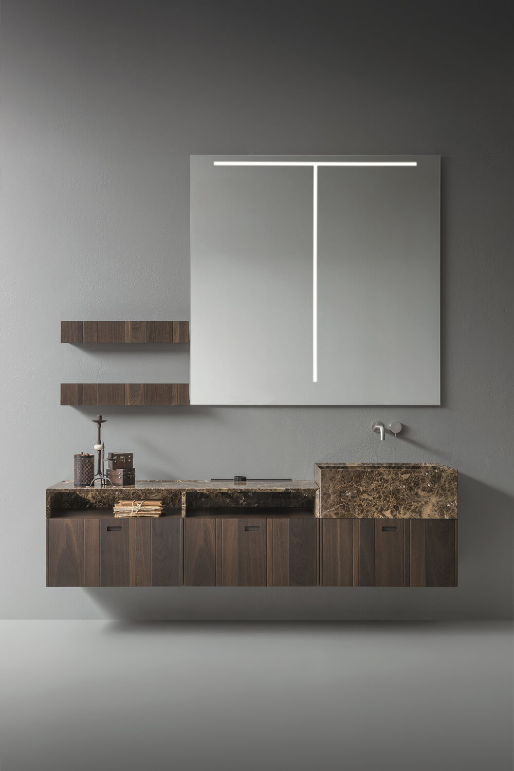 Flat cabinets with integrated handles and matching wall shelves. The washbasin integrates with the top. 