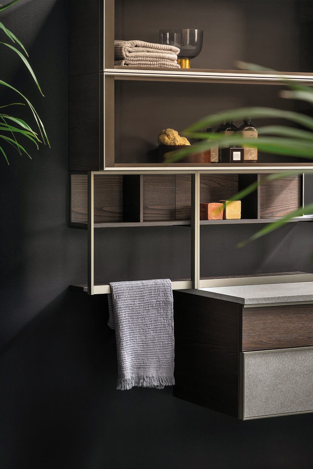 Open shelf system with a Titanium aluminum frame doubling up as towel rack.