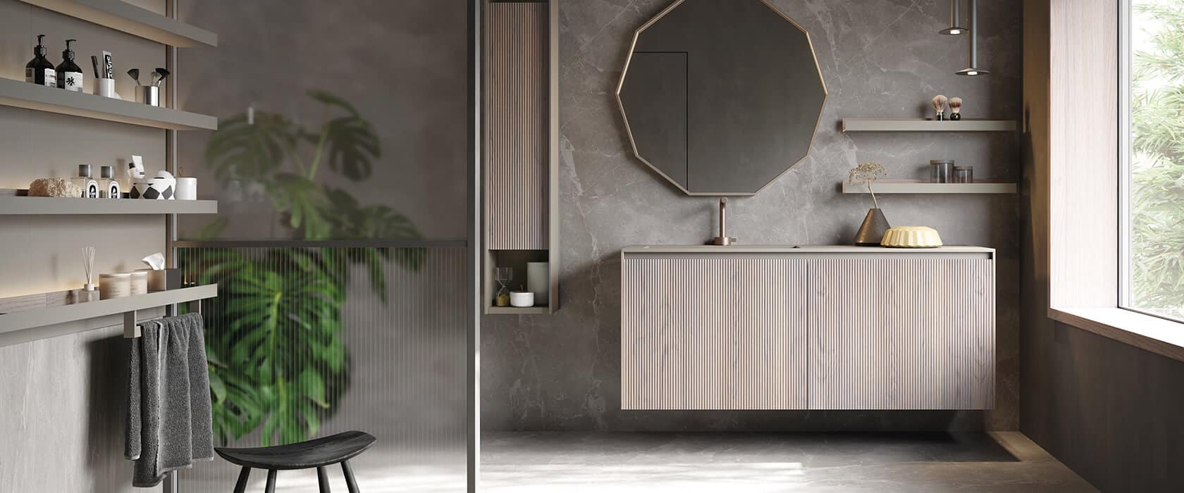 Vanity with plissé doors in Creta Oak mirrored by the door of the tall column, framed by a structure in Piombo matte lacquer. The ten-sided mirror adds visual variety and its frame in Piombo matte lacquer brings this sophisticated bath design full circle.  