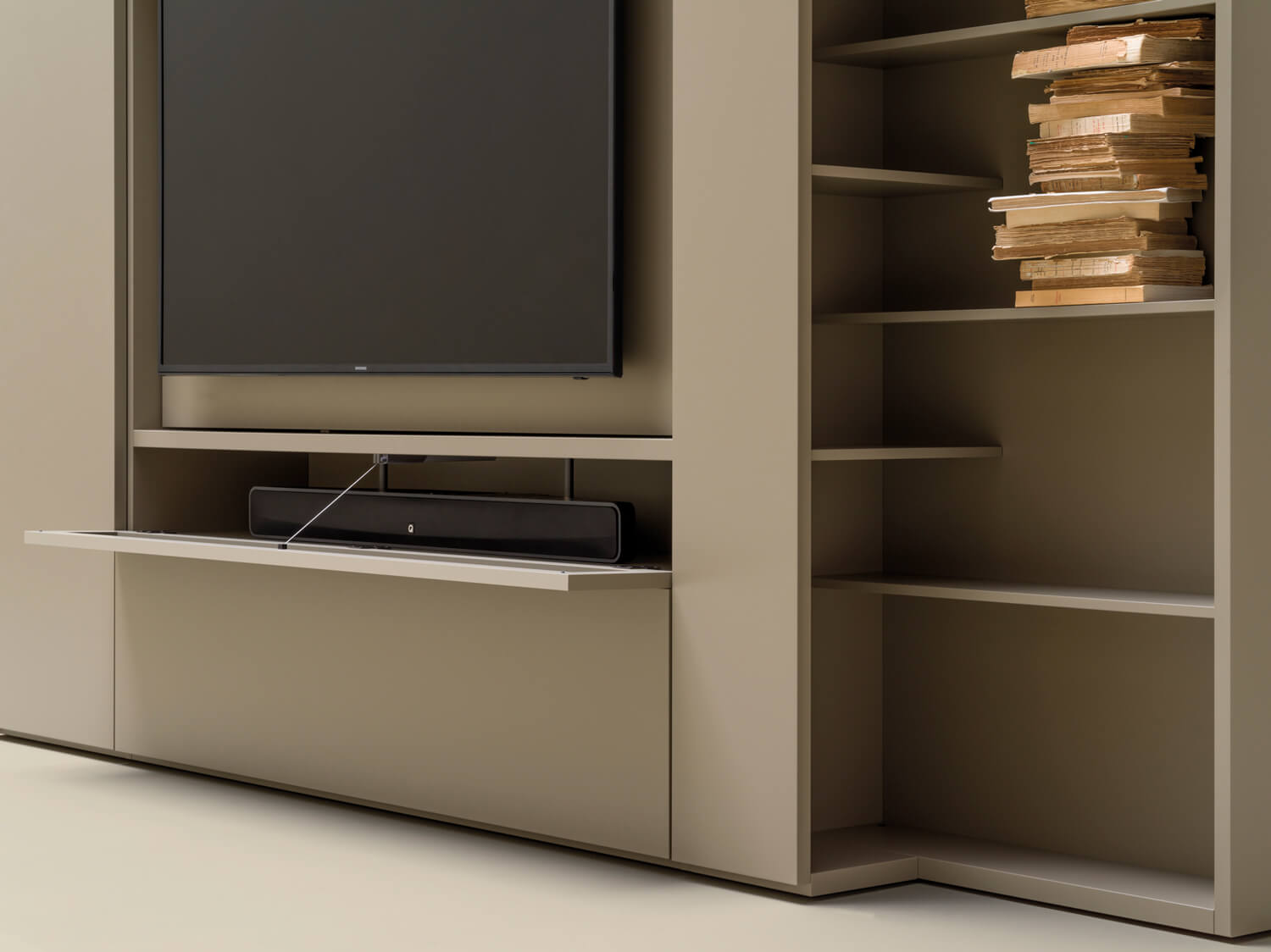 The compartment under the TV unit can house electronic devices and comes with or without front panel. The front panel is made to allow remote signals to come through. 