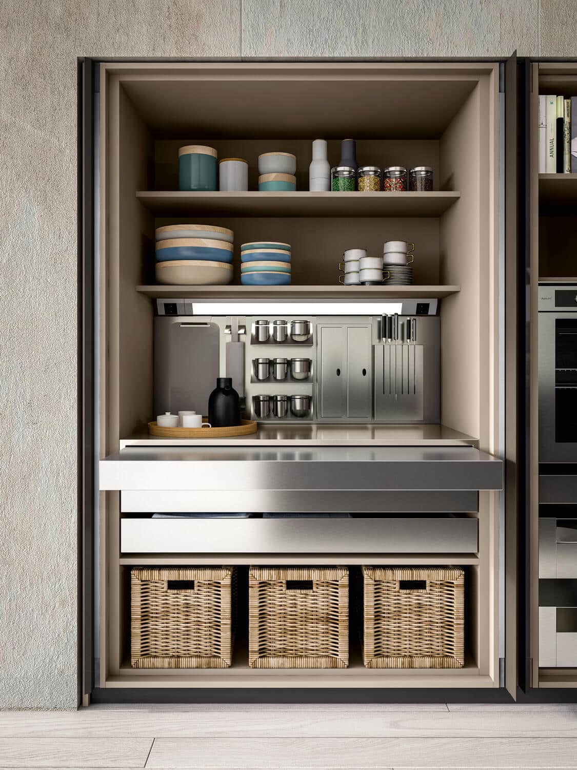The Wing system for the kitchen’s tall units features pocket doors. It can include custom wall accessories, drawers, and a pull-out stainless steel top for a practical extra surface. 