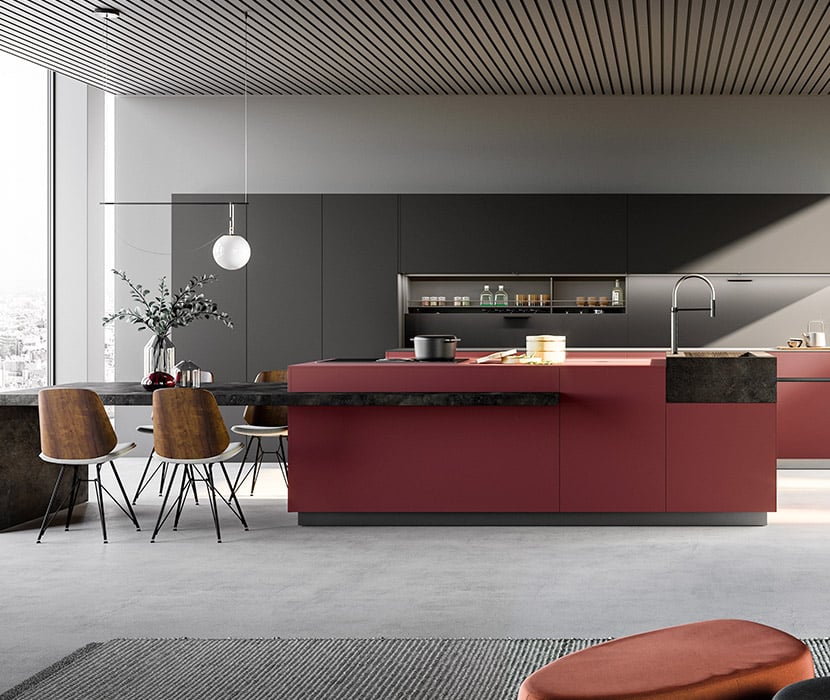 Luxury contemporary kitchen with large island and wall cabinets in penthouse setting. Smooth Black and red Fenix finishes. Made in Italy.