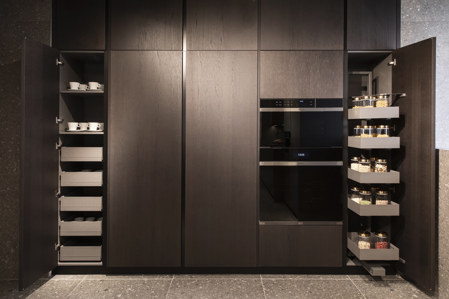 To the side of the same pantry unit, two cabinets with customized interiors based on the user's needs.