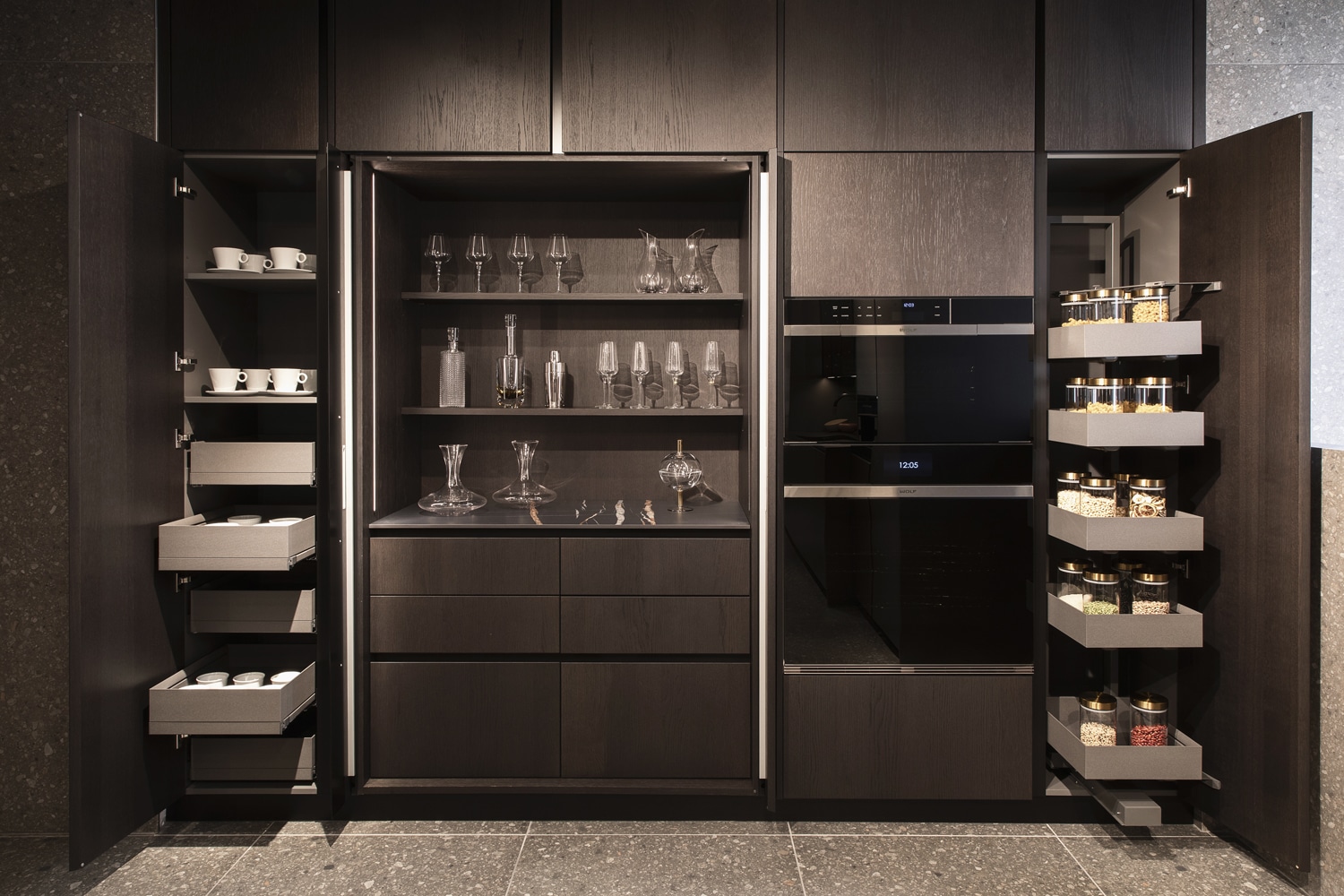 Pantry cabinets in Station wood with Wing pocket doors and full extraction storage baskets.
