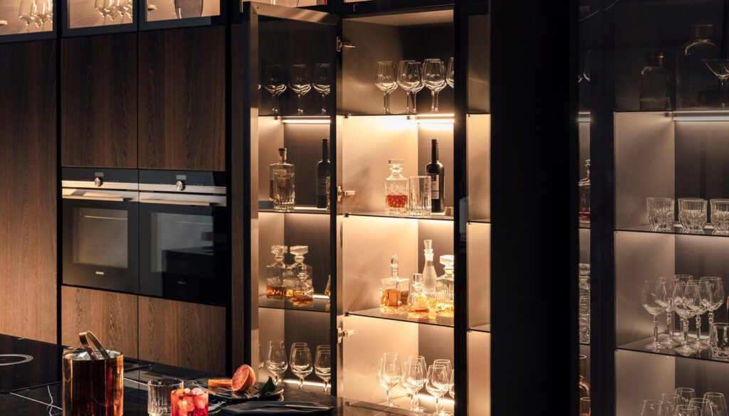 Luxury pantry with closed storage and smoked glass cabinets for bar area