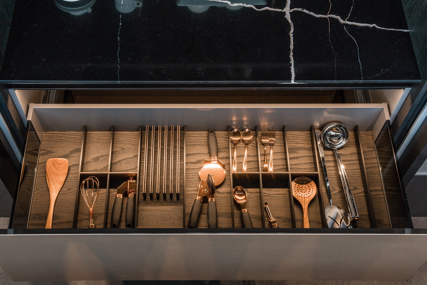 Yota kitchen drawer with custom inserts in dark oak wood.