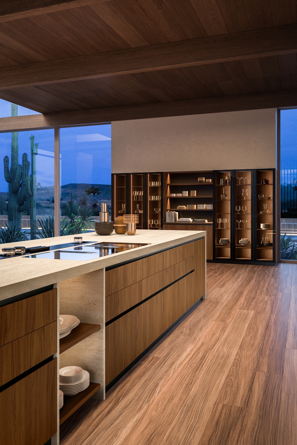 View of the island in walnut and the wall unit with glass cabinets with black frame and walnut back panels.