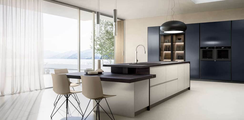 Luxury kitchen in dark blue and white micalized lacquer overlooking a lake.
