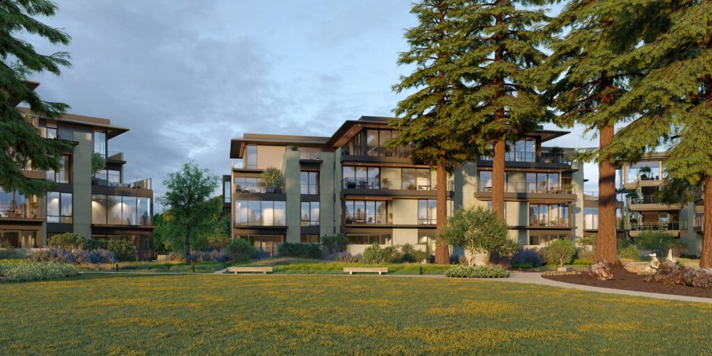 A modern apartment complex surrounded by trees and a grassy park.