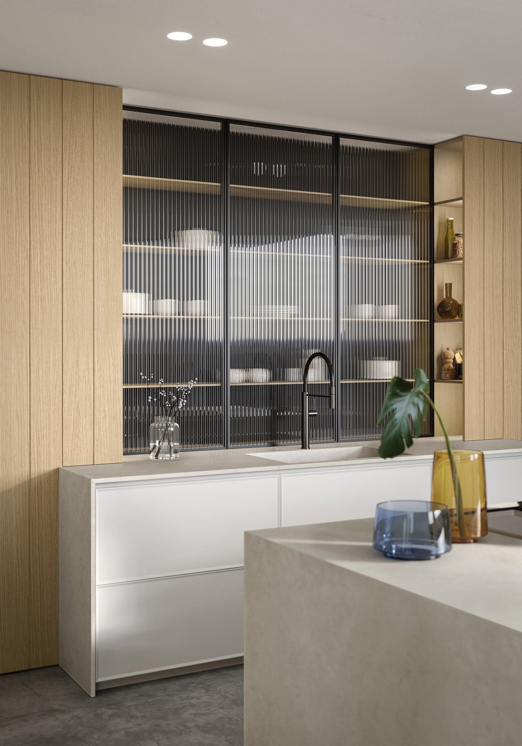 To both sides of the ribbed glass panel, integrated within the structure of the tall units, are LED-lit niches with open shelves.