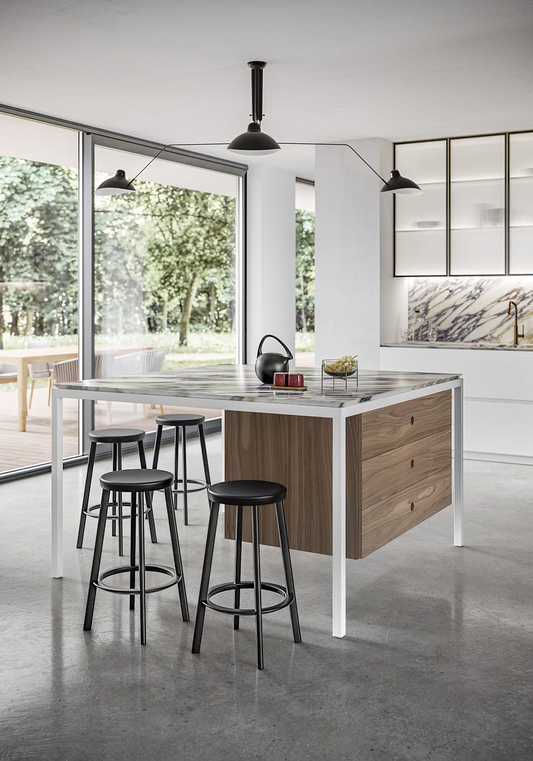 The square-shaped island/counter becomes a multifunctional space with the addition of a suspended set of drawers to store cutlery and other utensils. 