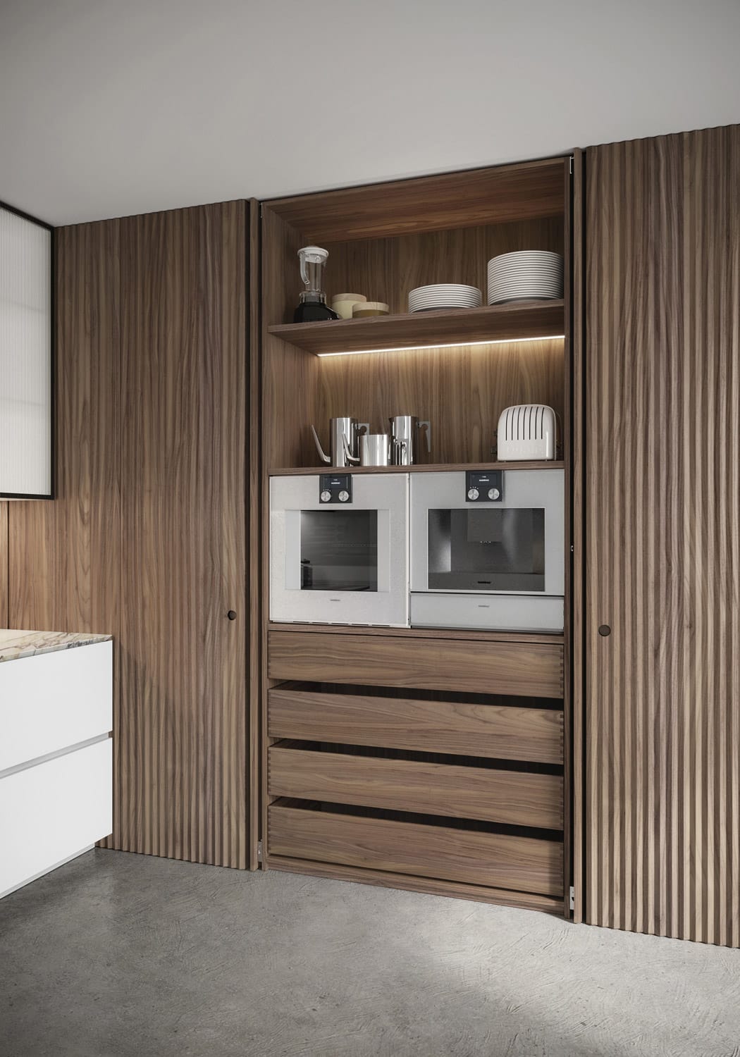 Each section of the pantry area was customized to the user’s needs. This unit has pocket doors that fold away inside the cabinet and interiors that match the Canaletto Walnut of the exterior doors. 