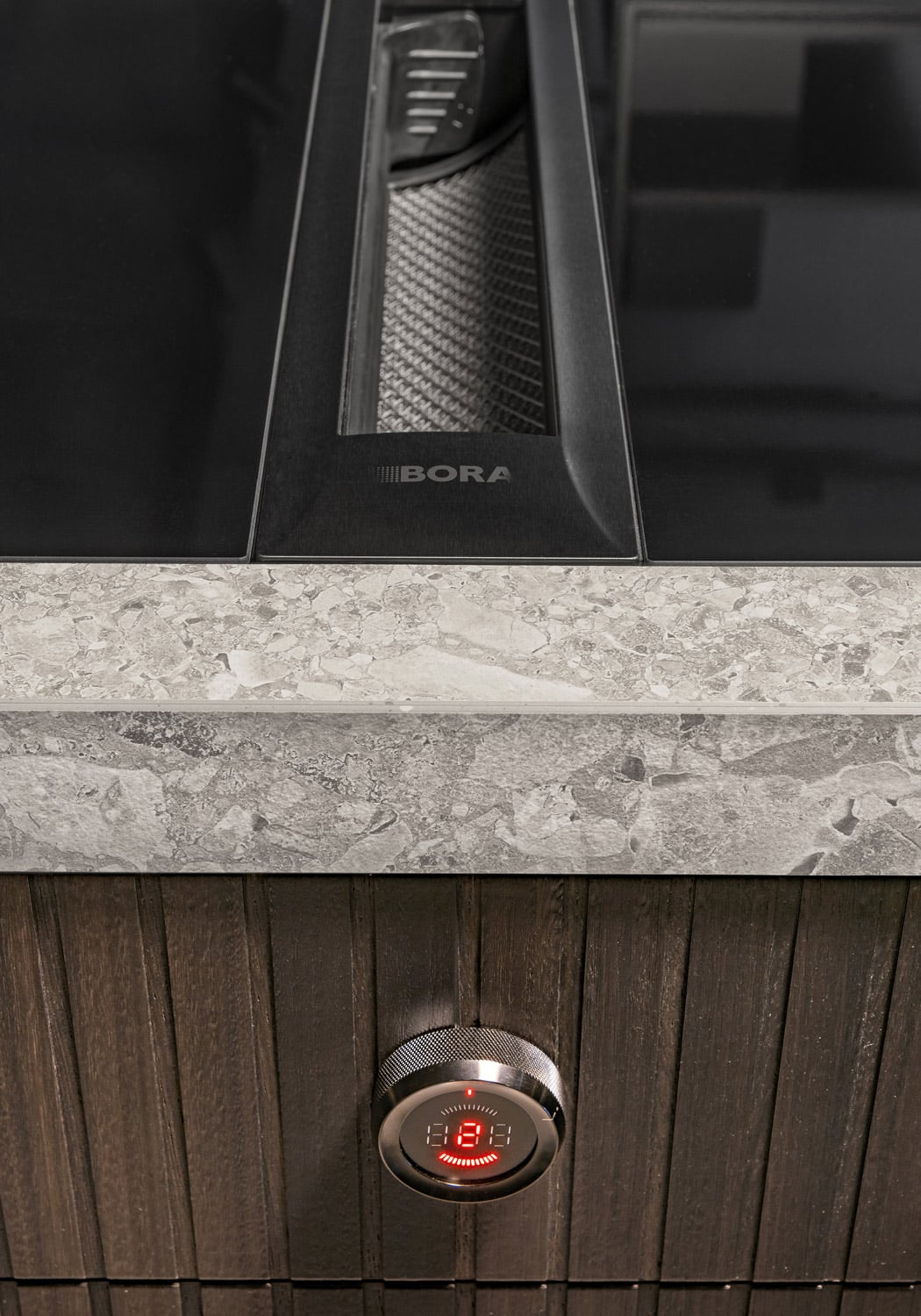 Detail of the ribbed cabinet in Smoked Eucalyptus and extra thick countertop in Atlas Kone Mix stoneware.