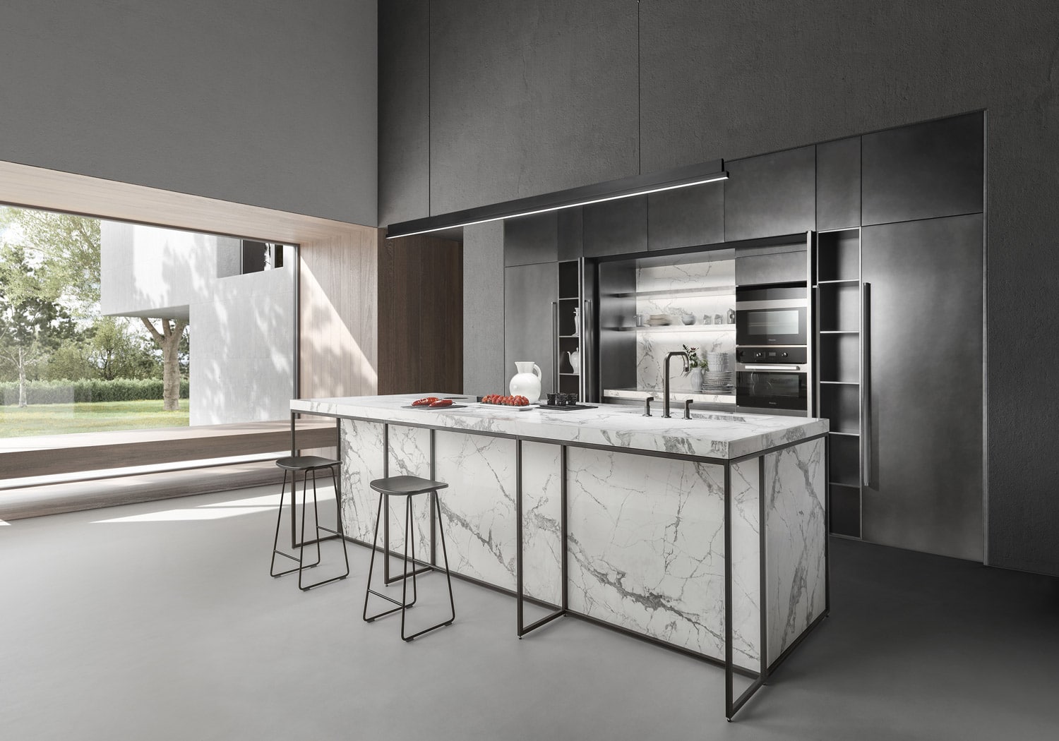 The central section of the tall units opens through a combination of single and bifolding pocket doors. The single pocket door reveals the appliances unit. The bifolding pocket doors disappear inside the cabinet to the left, revealing the niche made in Invisible White stoneware. 