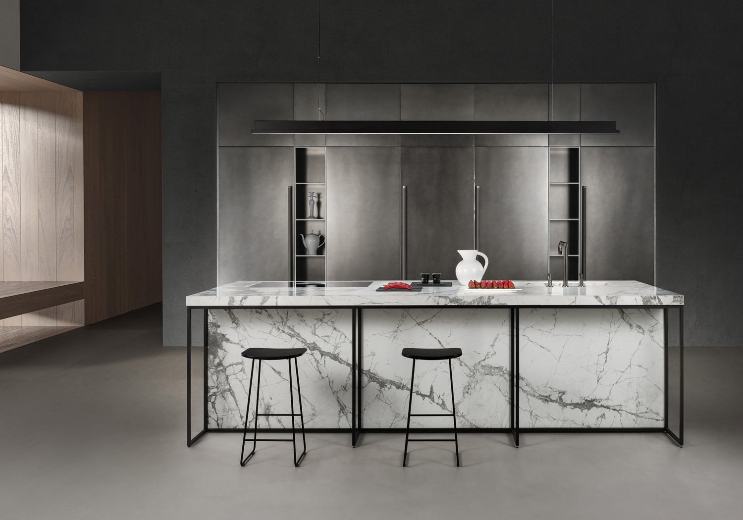 The stone and metal finishes balance each other with contemporary allure. The design is essential, yet detailed. The black metal frame used on the island further enhances the character of this custom kitchen.