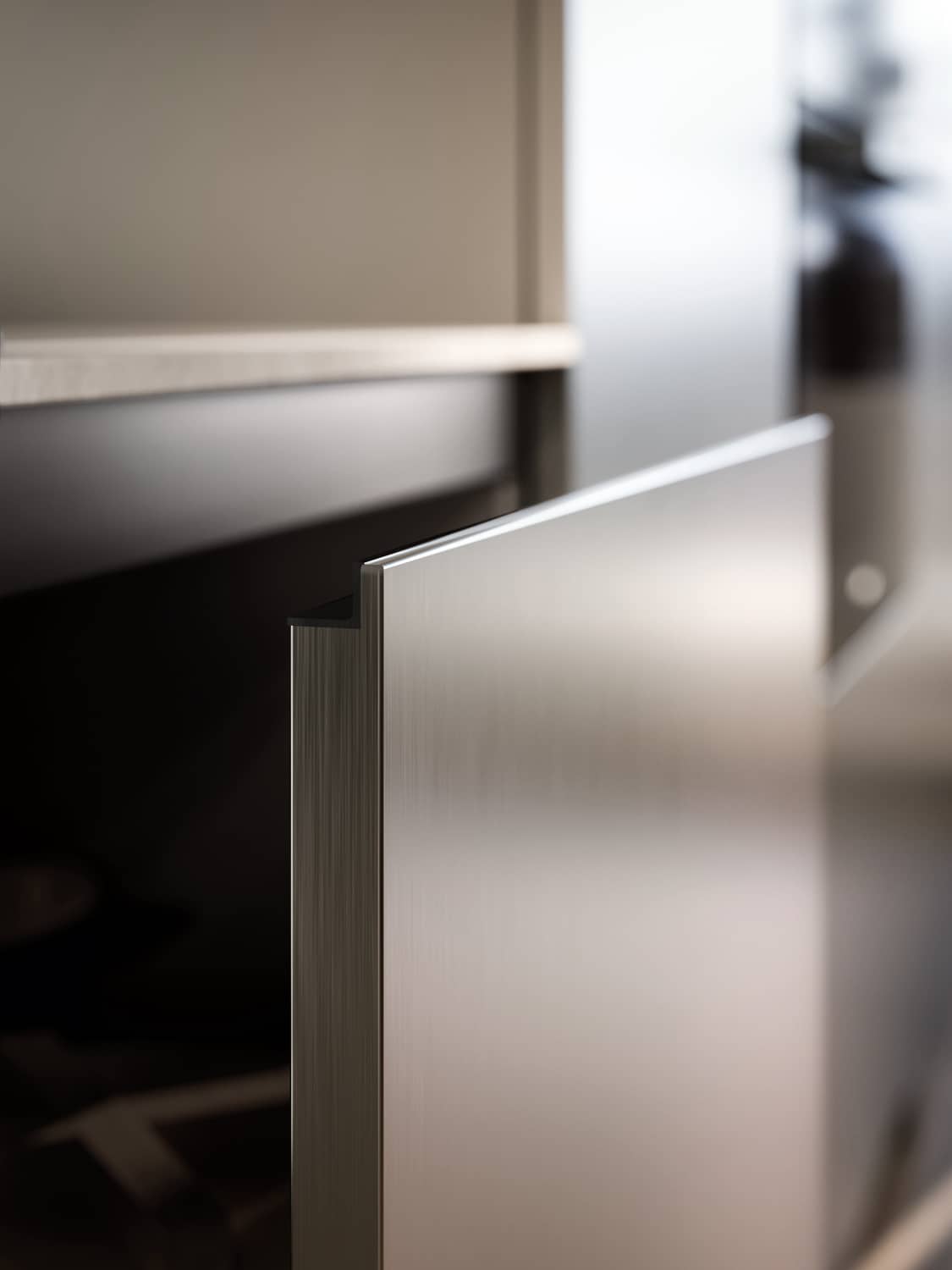 Detail of the Yota cabinet door in Ambra metallic lacquer with integrated Zeta handle.