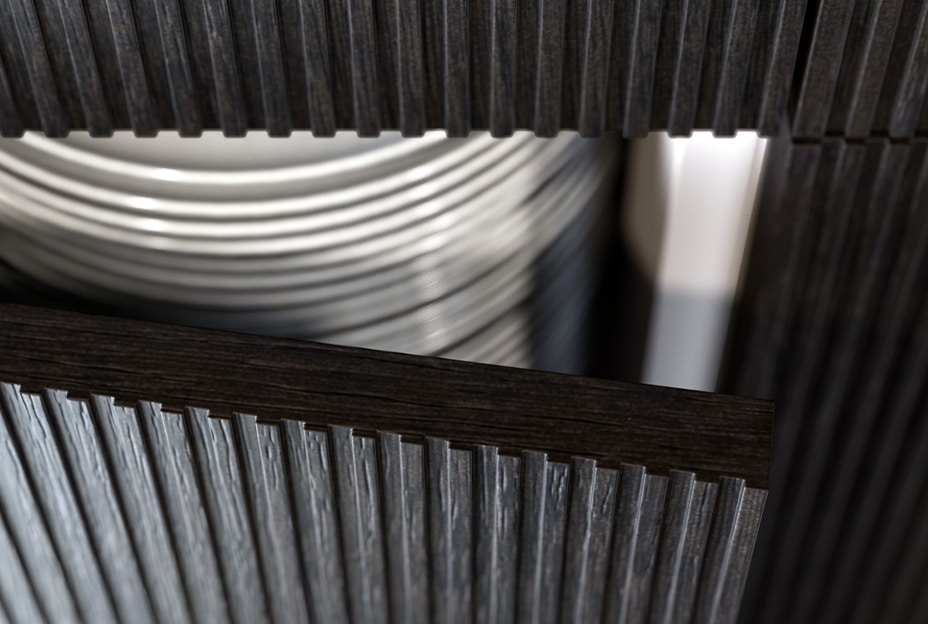 Close-up of a kitchen cabinet with vertical grooves and a stack of plates inside.