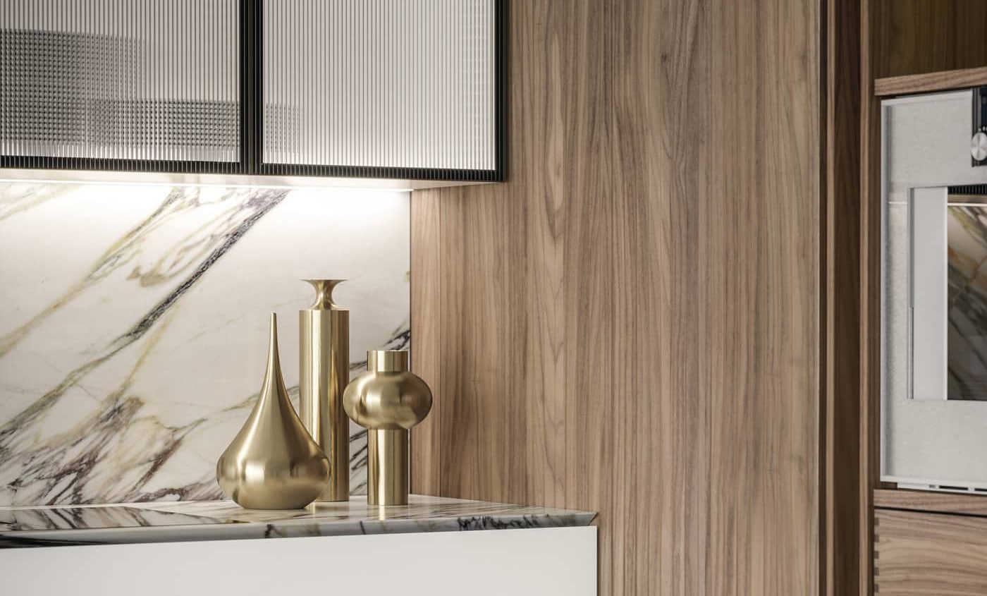 Detail of custom designed luxury kitchen in white lacquer, Canaletto Walnut, Calacatta marble and ribbed glass.