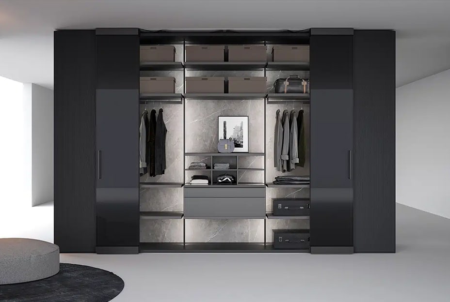 Modern walk-in closet with sliding doors, black cabinets, and marble-like wall panels.