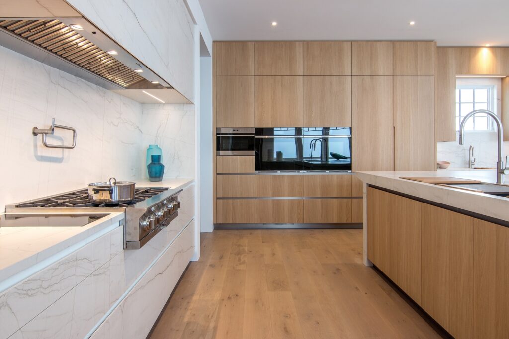 View of the kitchen's range top/hood area completely custom made in Neolith Mont Blanc