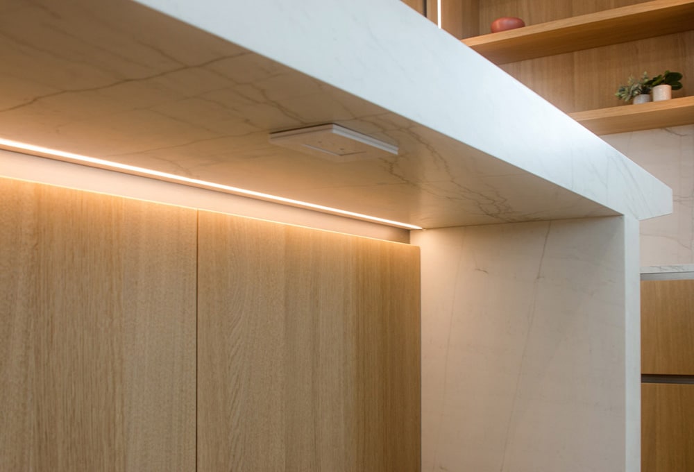 Detail of the LED lighting under the Neolith Mont Blanc kitchen island countertop