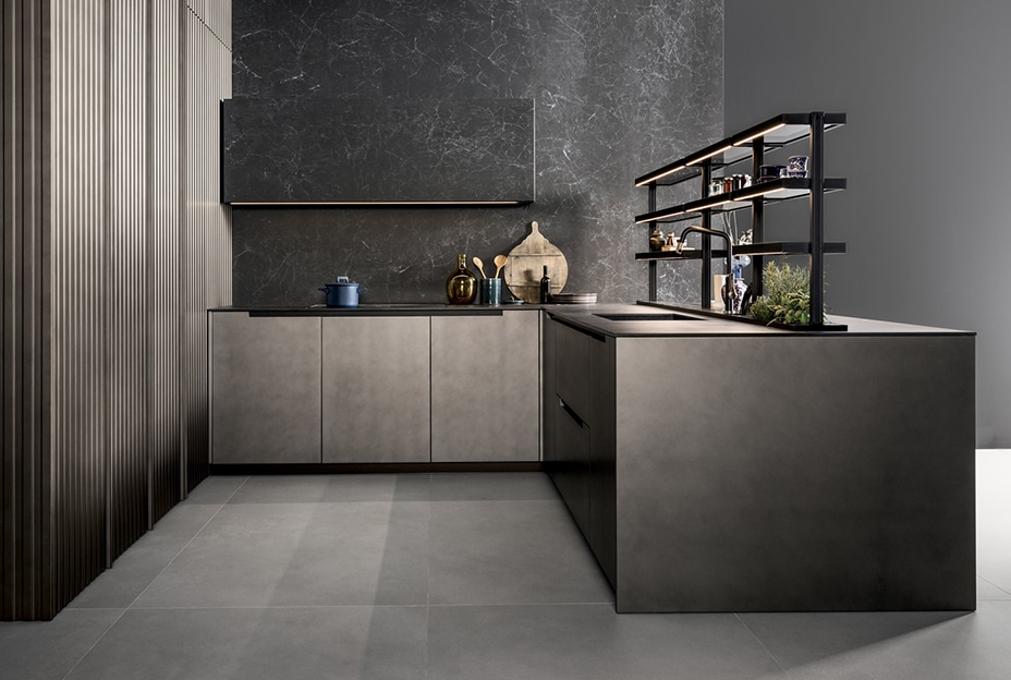 Modern kitchen with dark cabinetry, marble-like backsplash, and a large island.