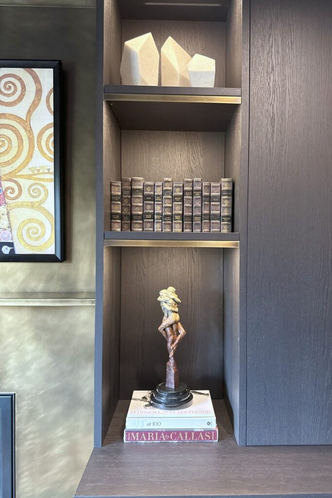 Italian luxury dark oak cabinets and open shelf niches with Richard MacDonald sculpture on display