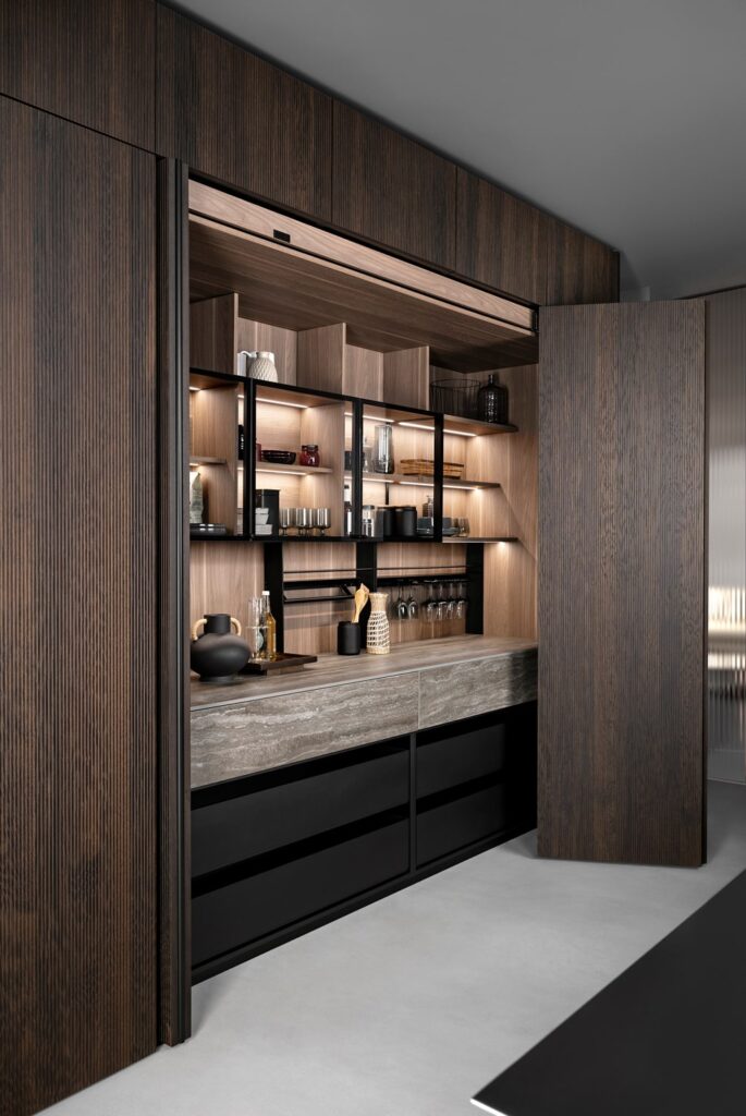 Luxury kitchen storage unit and workstation hidden behind bi-folding pocket doors.